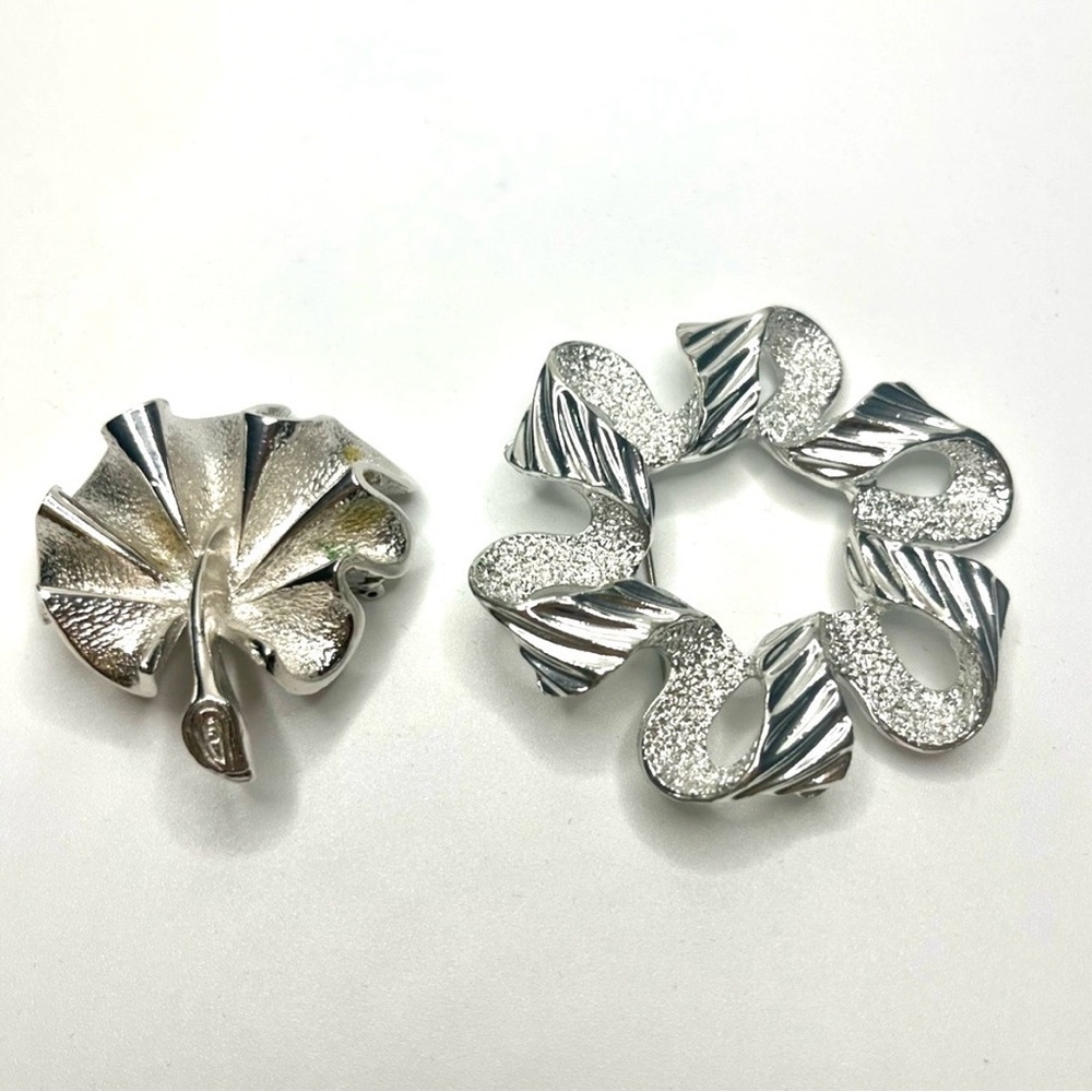 Two Elegant Silver tone Sarah Coventry brooches.